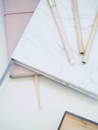 Pencils and notebook on white marble background - vintage effect style picturesの写真素材