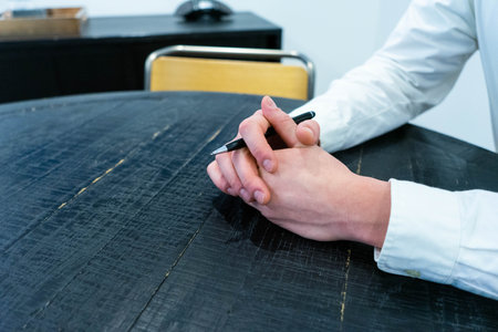Close-up of a man writing on a table