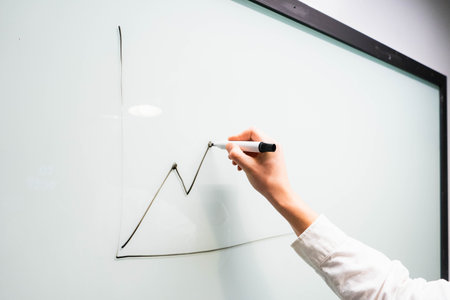 Businessman writing on a whiteboard. Business and finance concept.