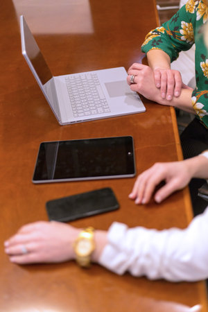 Group of business people discussing the charts and graphs showing the results of their teamworkの写真素材
