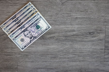 One hundred dollar bills on wooden background. Top view with copy space