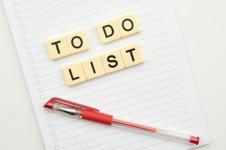 To do list with notebook and red pen isolated on white background.の写真素材