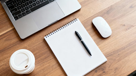 Laptop, coffee cup and notepad on the wooden desk.の素材