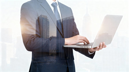 Double exposure of businessman working with laptop and modern cityscape on background.の素材