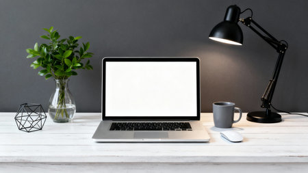 Laptop with blank screen on white wood table and gray wall backgroundの素材