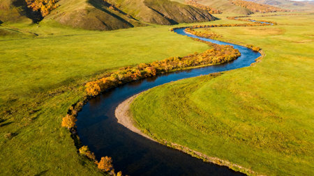 Aerial view of the autumn landscape with river and meadows.の素材