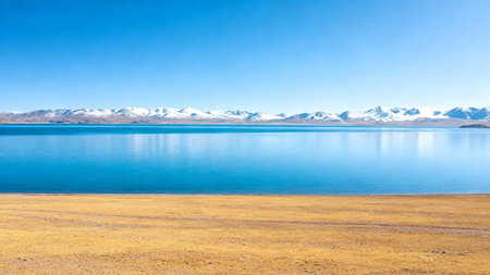 Snowy mountains and calm lake under blue skyの素材