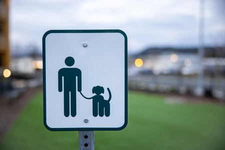 Pedestrian sign with a silhouette of a man and a dog.の写真素材