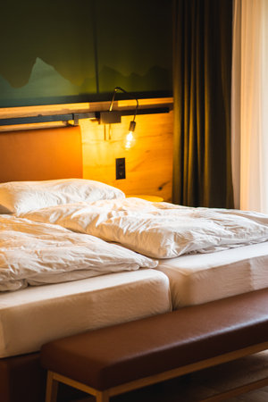 Double bed in hotel bedroom interior - Vintage Light Filter and Sun Flareの写真素材