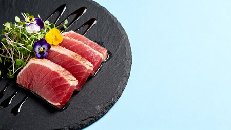Slices of seared tuna with garnishの素材