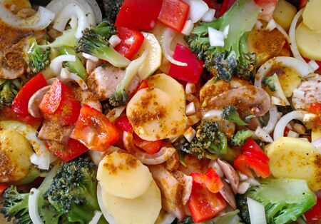 Colorful raw vegetable on roasting pan with spice ready to bakeの写真素材