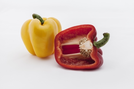 Fresh red and yellow pepper on white background.の写真素材