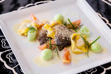 Fillet sea bass meuniere with vegetable and potatoes の写真素材
