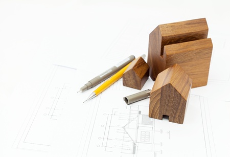 The wooden house model and blueprints 