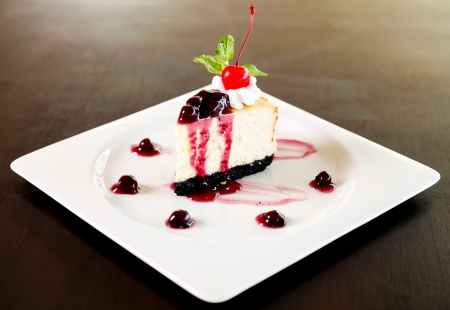 Cheesecake with berries sauce and cherry.の写真素材