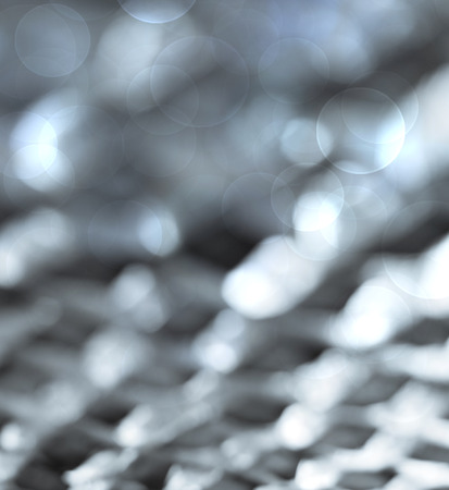 Silver colored  bokeh lights abstract background の写真素材