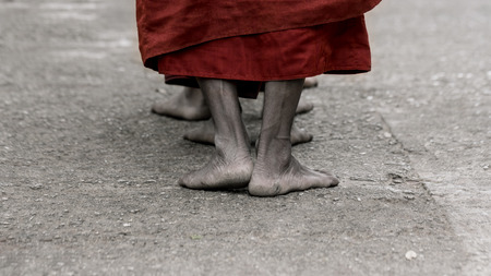 Foots of ascetic Buddhist monk walking at the way to  Kyaikhtiyo.の写真素材