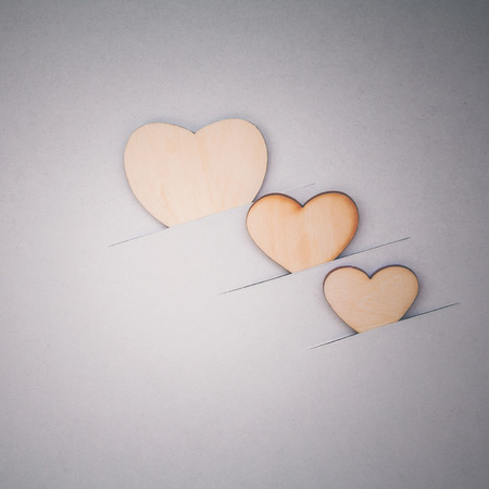 The wooden hearts on cardboard background. - Concept for love and wedding .の写真素材