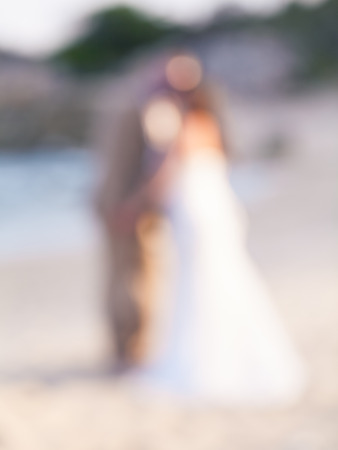 Defocus couple kissing on the beach , abstract blur background for card design, blurred wallpaper and illustration.の写真素材