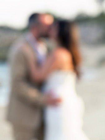Defocus couple kissing on the beach , abstract blur background for card design, blurred wallpaper and illustration.の写真素材