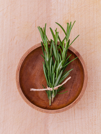 Fresh rosemary herbal medicine on wooden tableの写真素材