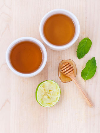 Cups of herbal  tea with aromatic herbal with lemon , lime and honey .の写真素材