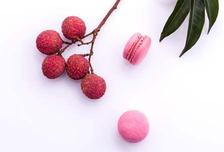 Brunch of ripe lychee and lychee macaroons with leaf isolate on white background.の写真素材