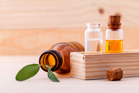 Natural Spa Ingredients sage essential oil for aromatherapy with sage leaf on wooden background.の写真素材