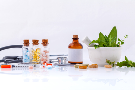Herbal medicine VS Chemical medicine the alternative healthy care with stethoscope isolate on white background.の写真素材