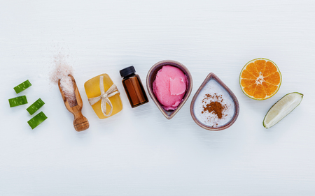 Homemade skin care and body scrubs with natural ingredients aloe vera ,lemon,cucumber ,himalayan salt ,tomato,mint ,lime slice,rosemary and honey set up on white wooden background with flat lay.の写真素材