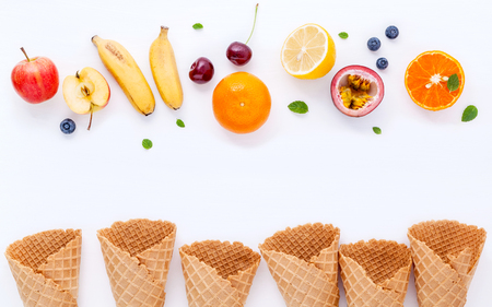 Flat lay various fresh fruits blueberry ,strawberry ,orange ,banana ,passion fruit ,apple and cherry setup on white background . Summer and Sweet menu concept.の写真素材