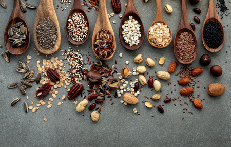 Different types of grains and cereals on shabby concrete