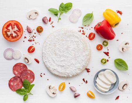 The ingredients for homemade pizza on white woodenの写真素材