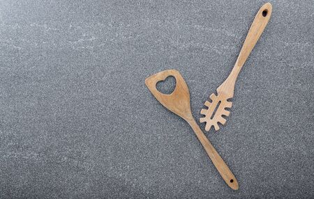 Pasta noodle spoon , Pasta scoop ladle  and  spatula on dark granite background with copy space.の写真素材