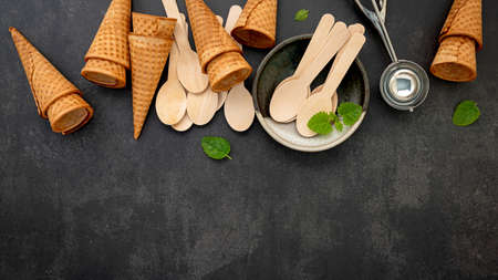 Flat lay ice cream cones collection on dark stone background . Blank crispy ice cream cone with copy...