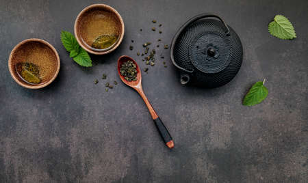 Black cast iron tea pot with herbal teaの写真素材