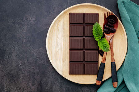 Food conceptual image with dark chocolate and fork on dark concrete background.の写真素材