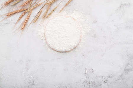 The ingredients for homemade pizza dough with wheat ears ,wheat flour and wheat grains set up on...