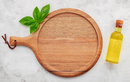 Empty wooden pizza platter set up on white concrete. Pizza tray on white concrete background flat lay and copy space.の写真素材