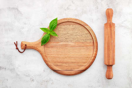 Empty wooden pizza platter set up on white concrete. Pizza tray on white concrete background flat lay and copy space.の写真素材