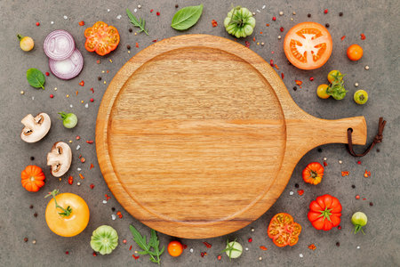 The ingredients for homemade pizza set up on dark stone background.の写真素材