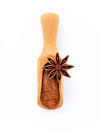 Close up chinese star anise in wooden scoop  isolate on white background. Dried star anise spice fruits top view and copy space.の写真素材