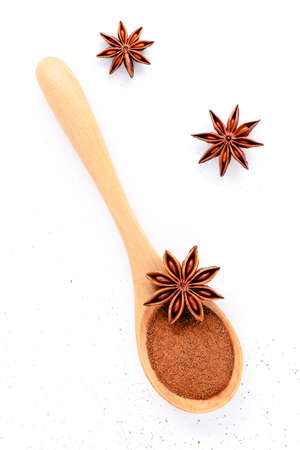 Close up chinese star anise in wooden spoon isolate on white background. Dried star anise spice fruits top view and copy space.の写真素材