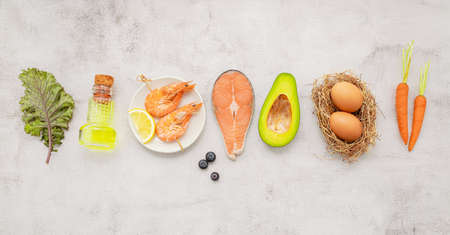 Ketogenic low carbs diet concept. Ingredients for healthy foods selection set up on white concrete...