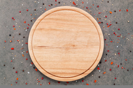 Empty pizza platte with spices set up on dark concrete background flat lay and copy space.の写真素材