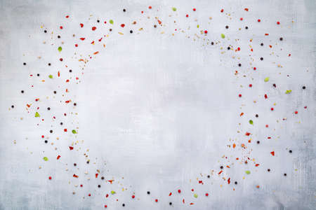 Top view of dark concrete background with peppercorn and chilli flakes.の写真素材