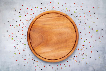 Empty pizza platte with spices set up on dark concrete background flat lay and copy space.の写真素材