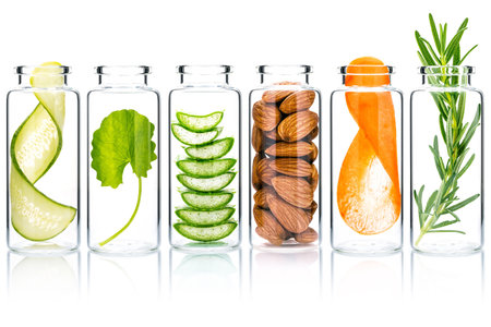 Homemade skin care with natural ingredients  aloe vera ,cucumber ,almonds, centella asiatica and rosemary in glass bottles isolate on white background.の写真素材