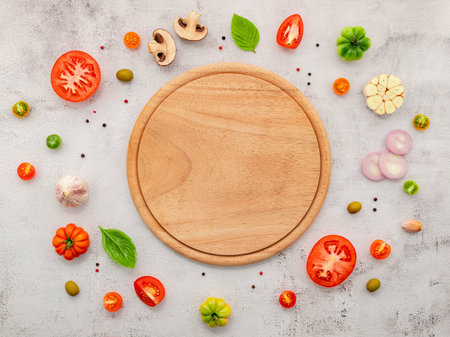 The ingredients for homemade pizza set up on white concrete background.の写真素材