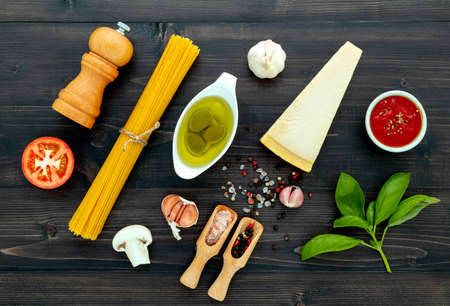 The  pasta on black wooden background. Yellow italian pasta with ingredients. Italian food and menu concept.の写真素材